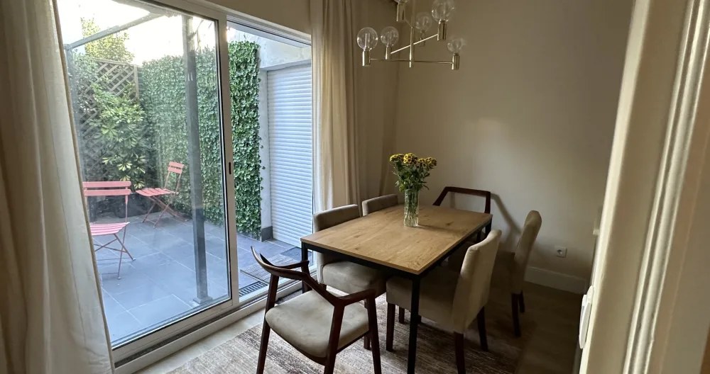 Dining table for four beside the garden doors