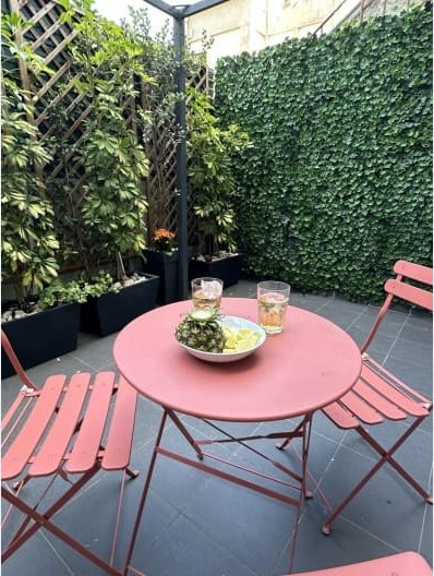 Pink bistro table set with drinks on the private terrace