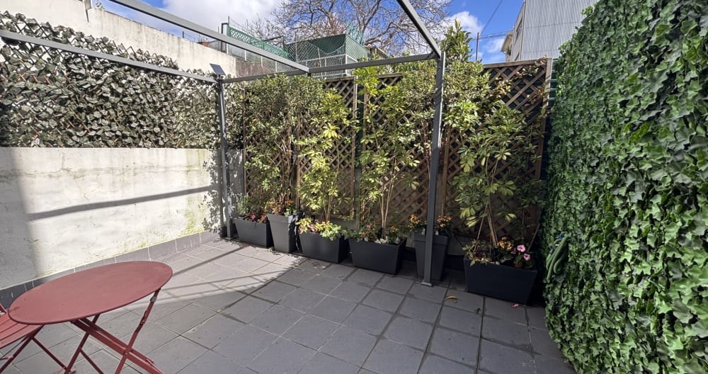 The private terrace lined with planters and greenery